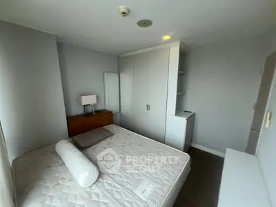 Spacious bedroom with modern furniture and ample storage in a stylish apartment.