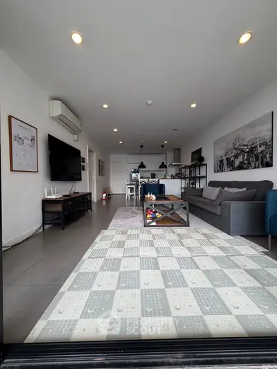 Spacious modern living room with stylish decor and open layout, perfect for relaxation and entertainment.