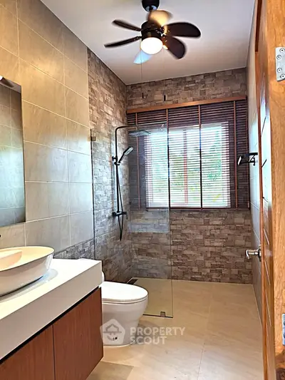 Modern bathroom with stylish fixtures and glass shower enclosure