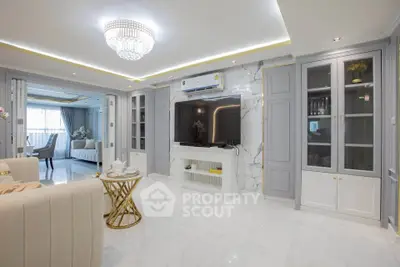 Luxurious living room with elegant decor and modern furnishings, featuring a stunning chandelier and marble accents.