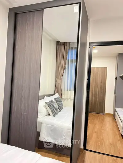 Modern bedroom with sleek sliding wardrobe and cozy bed setup