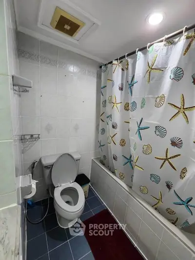 Cozy bathroom with starfish-themed shower curtain and modern fixtures.