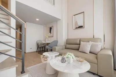 Modern living room with elegant decor and staircase in stylish apartment