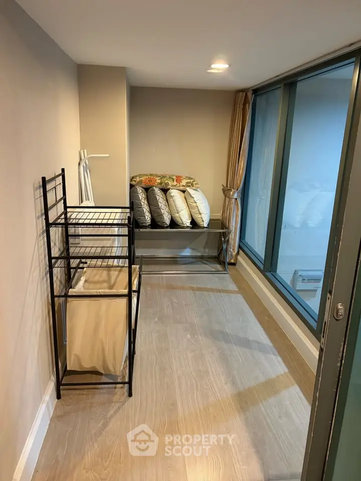 Cozy storage room with large window and modern shelving unit, perfect for organizing and maximizing space.