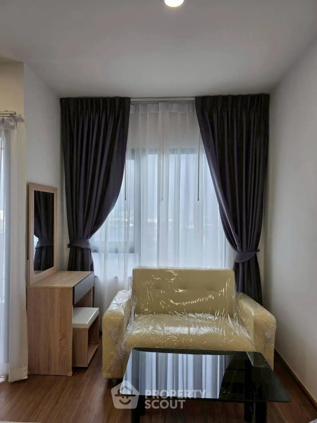 Cozy living room with elegant curtains and modern furniture, perfect for relaxation and comfort.