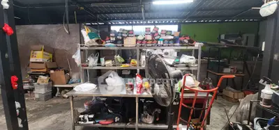 Industrial storage space with metal shelves and various tools and equipment.