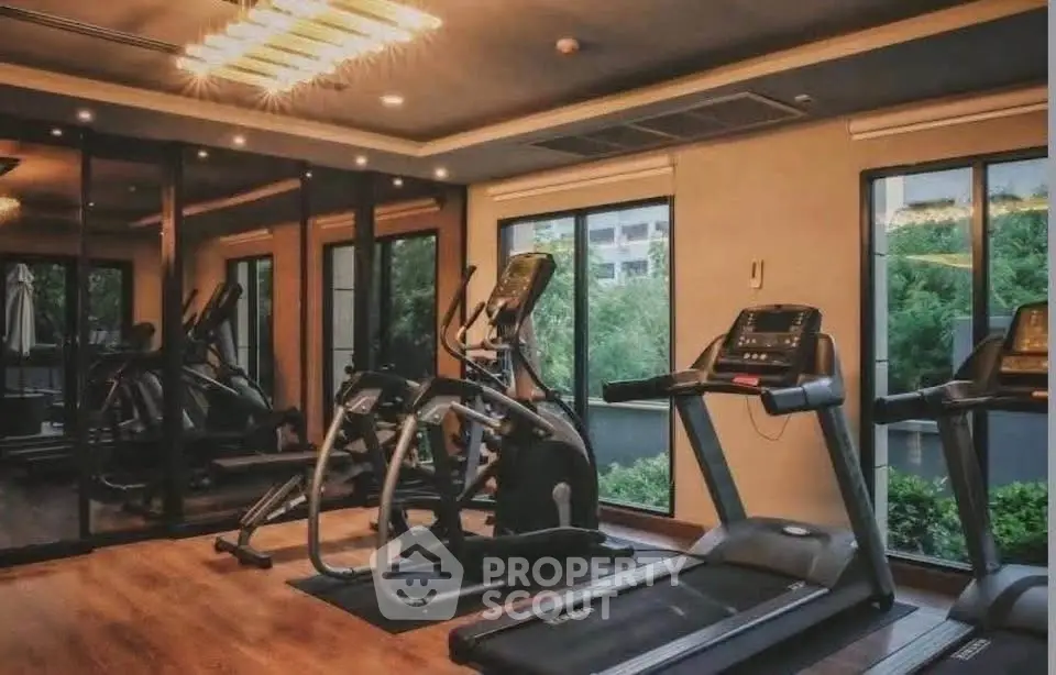 Luxurious gym with modern equipment and scenic views in upscale residential building.