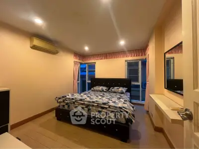 Cozy bedroom with modern decor and ample natural light