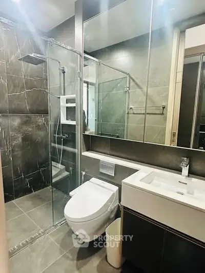 Modern bathroom with sleek design, glass shower, and contemporary fixtures.