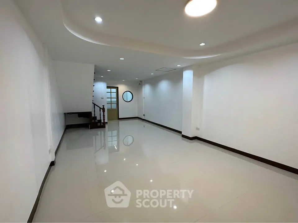 Spacious modern living room with sleek design and recessed lighting
