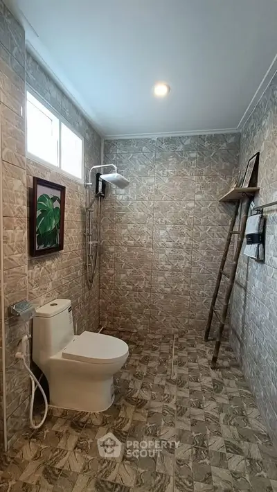 Modern bathroom with stylish tile design and rainfall showerhead