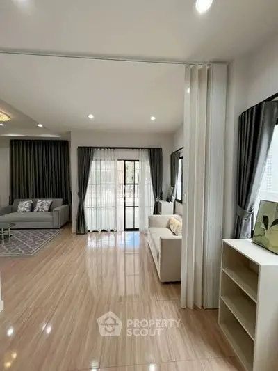 Spacious living room with elegant decor and large windows for natural light