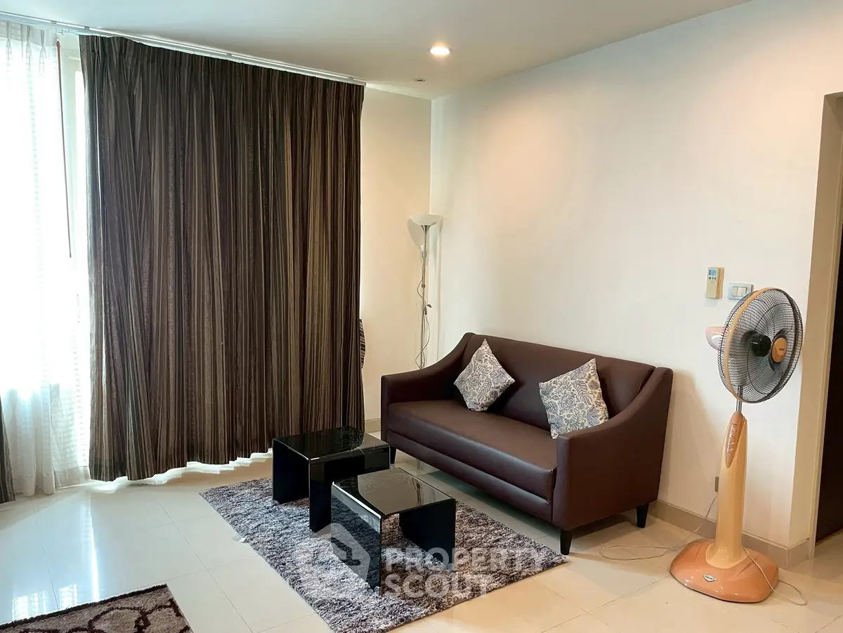 Modern living room with stylish sofa, elegant curtains, and chic coffee tables in a cozy apartment.