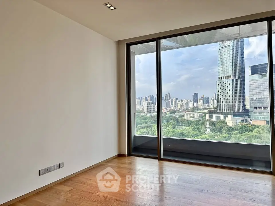 Spacious modern apartment with stunning cityscape view and large windows.