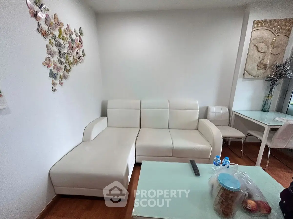 Modern living room with white sectional sofa and artistic wall decor