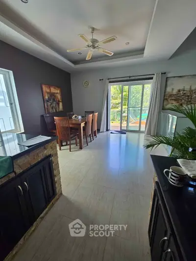 Spacious dining area with natural light and balcony access in modern home