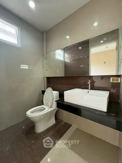 Modern bathroom with sleek fixtures and large mirror