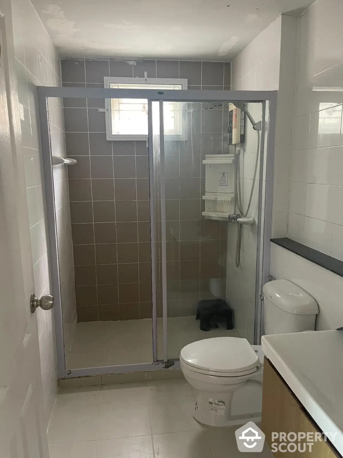 Modern bathroom with glass shower enclosure and sleek fixtures