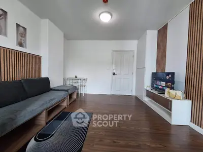Modern living room with sleek wooden flooring and stylish decor