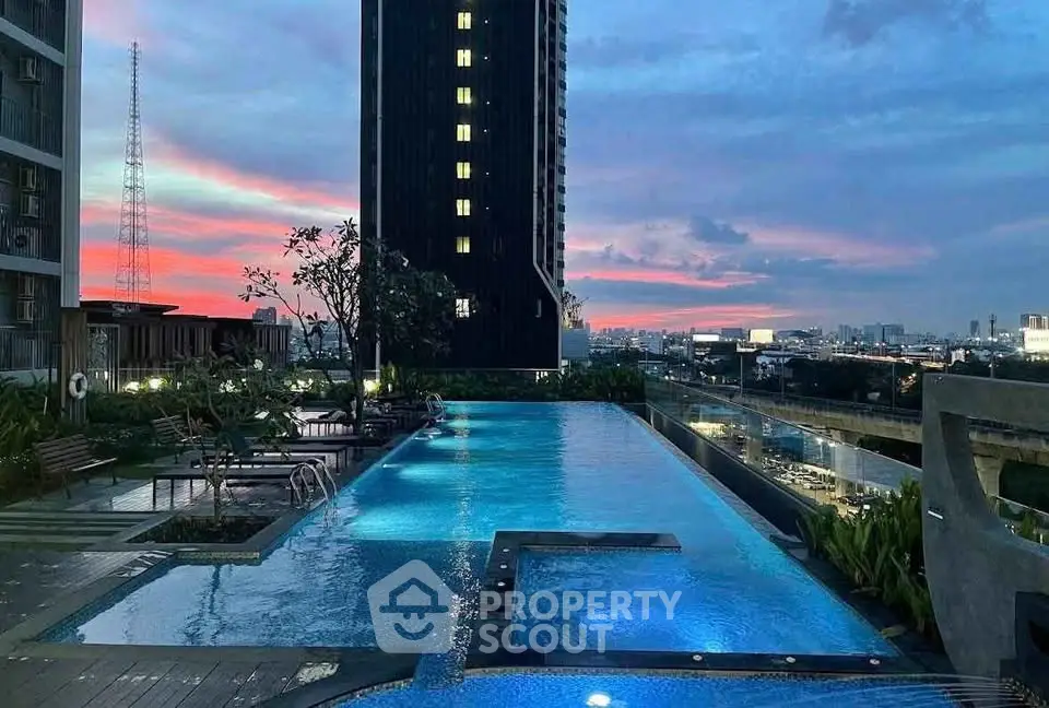 Stunning rooftop pool with city skyline view at sunset, perfect for luxury living.