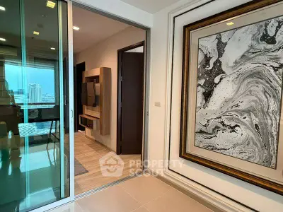 Modern apartment interior with stylish decor and sliding glass doors leading to a balcony with city view.