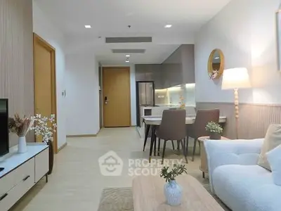 Modern living room with dining area and stylish decor in a cozy apartment.
