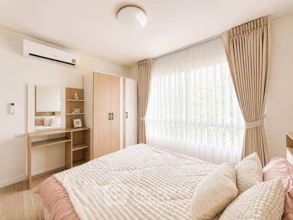 Bright and cozy bedroom with large window and elegant decor
