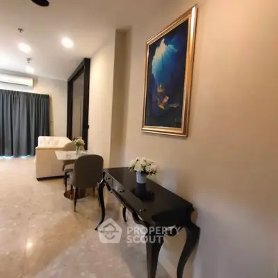 Elegant living room with stylish furniture and art, featuring a cozy seating area and modern decor.