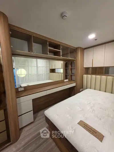 Modern bedroom with built-in wooden storage and elegant decor