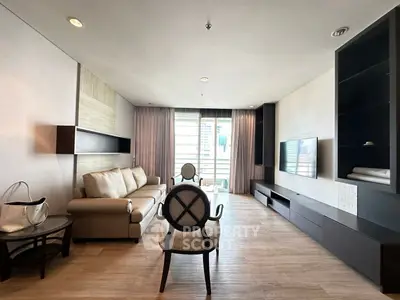 Elegant living room with modern furniture and large window offering natural light.