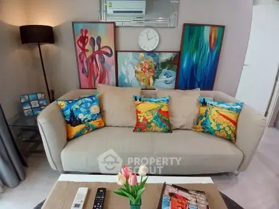 Stylish living room with vibrant art and cozy sofa, perfect for modern living.