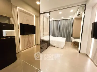 Modern studio apartment with sleek design, featuring a cozy bedroom and stylish living area.