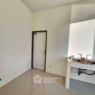 Minimalist kitchen with white walls and sink, ideal for modern living.
