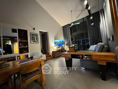 Spacious modern living room with high ceiling and stylish wooden furniture