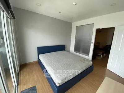 Spacious bedroom with modern design and large windows for natural light