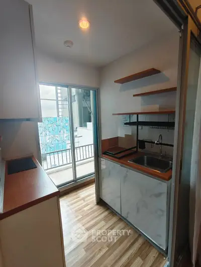 Compact kitchen with modern design and balcony access