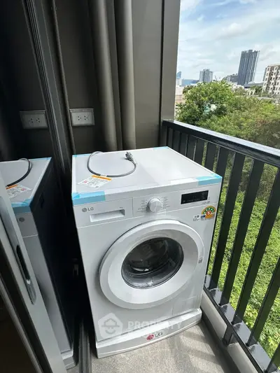Modern washing machine on a balcony with city view, perfect for urban living convenience.