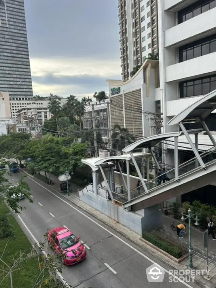 Urban street view with modern buildings and pedestrian bridge