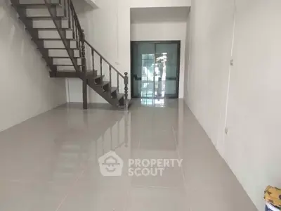 Spacious modern interior with sleek staircase and glossy tiled floors