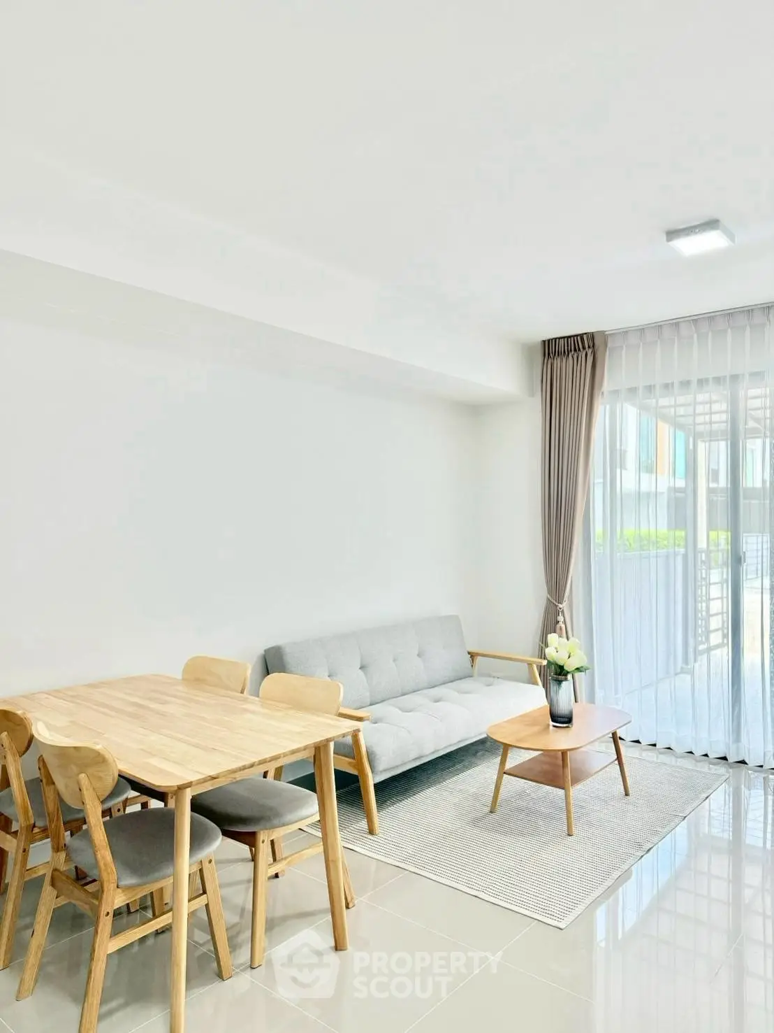 Bright and modern living room with dining area and natural light