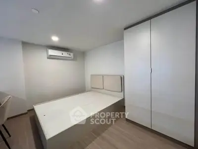 Modern minimalist bedroom with sleek wardrobe and air conditioning