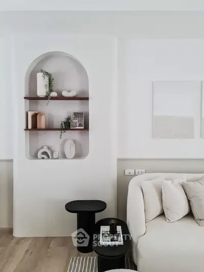 Stylish modern living room with elegant built-in shelving and cozy sofa.
