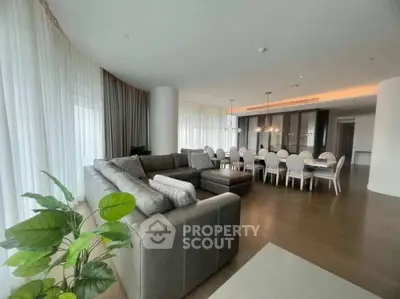 Spacious modern living room with elegant dining area and large windows