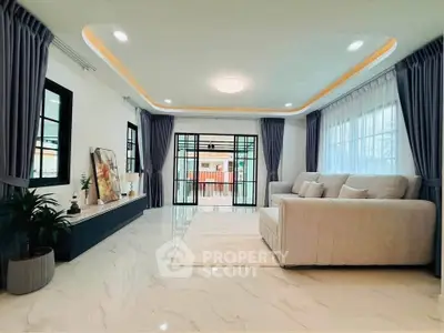 Spacious modern living room with elegant decor and large windows for natural light.