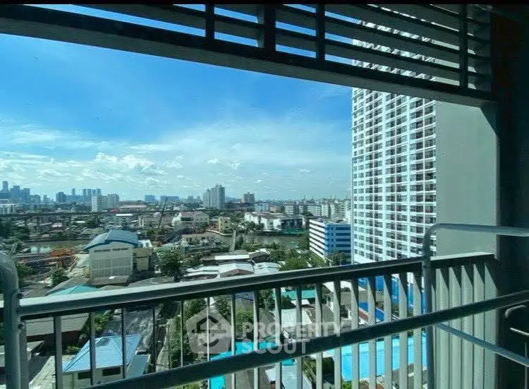 Stunning cityscape view from high-rise balcony with clear blue skies.