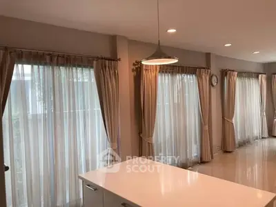 Elegant kitchen with large windows and modern lighting