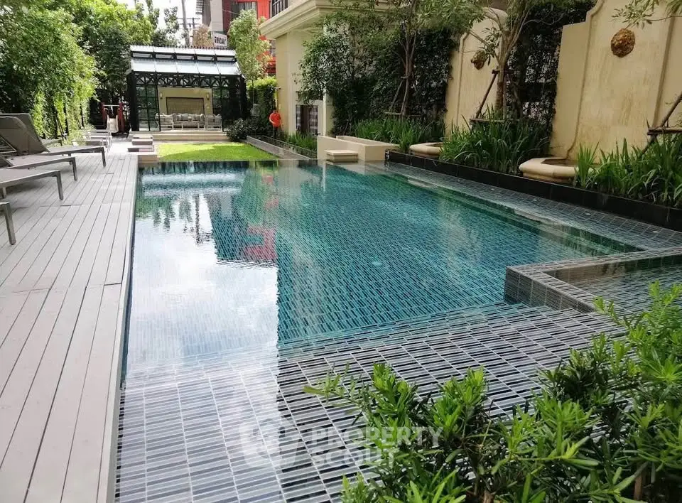 Luxurious outdoor pool area with lush greenery and modern design