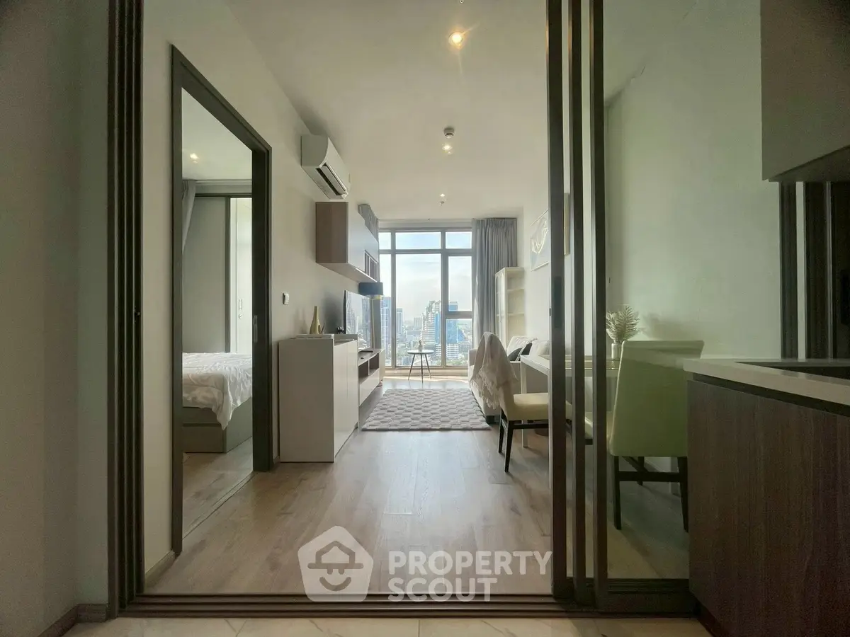 Modern apartment interior with open layout and city view, featuring stylish living room and bedroom.