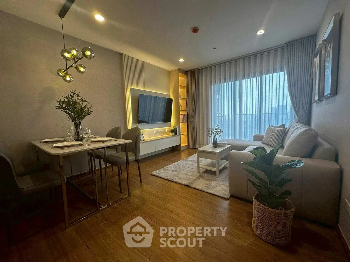 Modern living room with elegant decor and natural light, featuring a cozy seating area and stylish dining space.