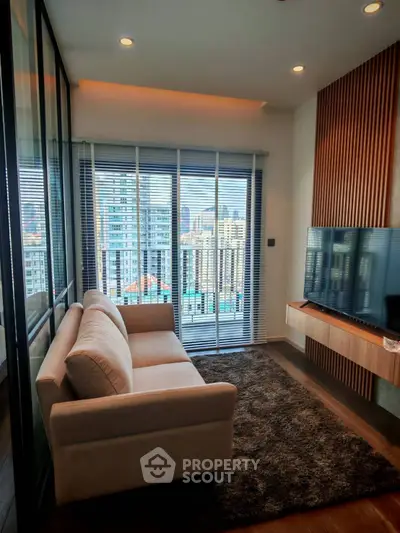 Modern living room with city view, cozy sofa, and large TV, perfect for urban living.